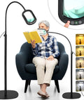 Woman reading with 5X Rectangular Magnifying Floor Lamp With 24-Inch Flexible Gooseneck, adjustable stand in use.