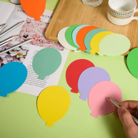 Person decorating 360 Die Cut Paper Balloon Cutouts 3.9 Inch Assorted Colors with pencils for classroom DIY crafts