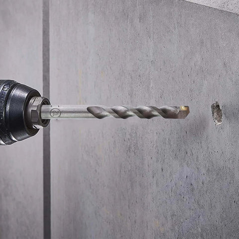 Installed SDS‑Plus masonry drill bit (12 mm) in a hammer drill drilling into concrete wall.