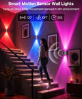 GOODEA RGB Wall Sconce, Rechargeable Motion Sensor Wall Light with Remote illuminating a staircase with vibrant colors.