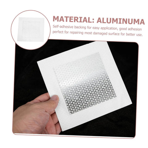 Hand holding a self-adhesive square wall patch with mesh design from the 12 Piece Self Adhesive Wall Patch Kit With Sturdy Mesh Drywall Patches For Quick Hole Repair In Home And Office Use Easy To Apply No Mess Patch That Leaves A Smooth Flat Finish Great For Walls Ceilings And Apartments, material labeled as aluminum.