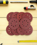 150 Pcs 8-Hole Sanding Discs With Loop Back For Smooth Grinding On Metal Plastic And Wood, Premium Dry Sandpaper Sheets stacked.