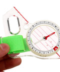 Thumb Type Directional Compass For Outdoor Navigation, Portable Hiking Tool in durable acrylic with a green strap, close-up view