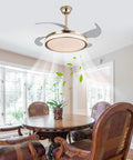 Semokia Ceiling Fan Light with Remote Gold Fan for Bedroom Living Room installed in a dining area with a round wooden table.