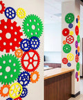 Decorative wall with Colorful Gear Shaped Felt Decor Mats Set Of 48 In Four Sizes 3.1, 4.7, 6.2, 7.8 Inches for classroom and party decor.