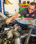 Man cleaning car engine using Soft Natural Bristle Wheel And Rim Cleaning Brush With Gerbil Hair For Wheels Rims Exhaust Tips