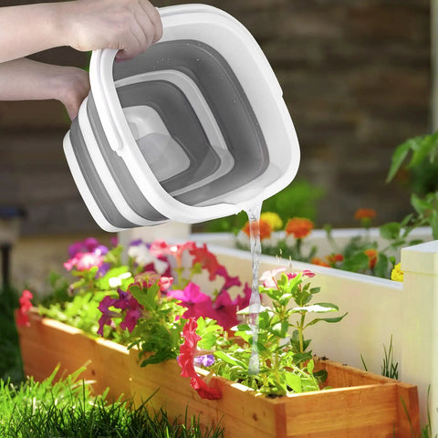 Foldable Collapsible Water Bucket 5 Liter One Point Three Gallon in use, watering colorful flowers in a garden, BPA Free TPR plastic