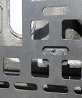 Close-up of Universal MOLLE Panel Mounting Bracket Base Matte Black Steel 4 Pack installed on vehicle panel system.