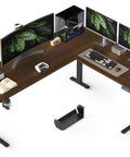 Big Game Changing L Shaped Standing Desk With Cup Holder Electric Height Adjust Corner Computer Workstation Ergonomic Sit Stand Up Home Office Gaming Station Spacious Black Walnut Finish with dual monitors and workspace accessories.