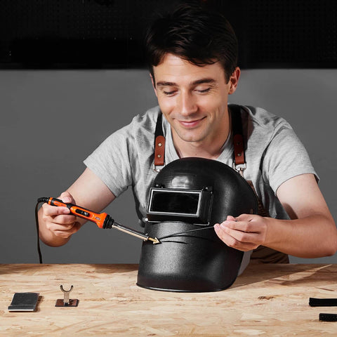 Man using Dual Power Plastic Welder Kit with 60W and 100W soldering iron on black plastic item on workbench.