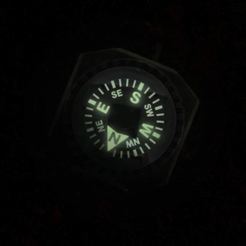 Glowing face of slip on wrist compass for survival gear and outdoor adventurers, easy read back up nav tool, ideal for watch band or paracord.