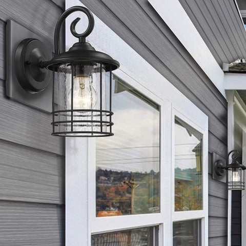 Slim 5.5 Inch Wide Outdoor Wall Light 2 Pack in Textured Black with Seedy Glass installed on house exterior near window.