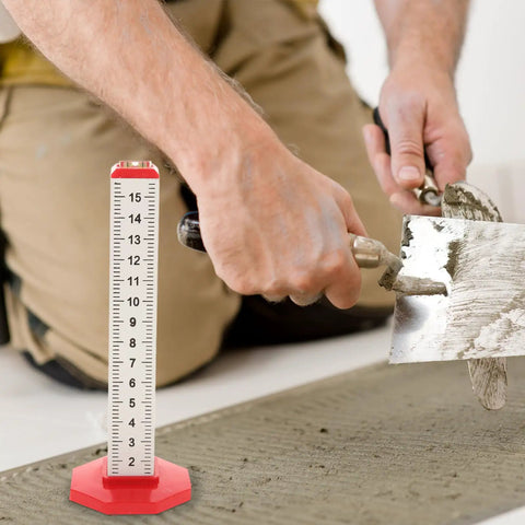 Dual Function Tile Contour Gauge And Ruler Level Tool in use during tile installation, measuring concrete layer height, red marker