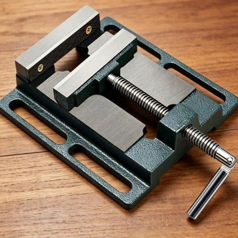 Beefy Bench Vise For Drill Press And Table Mounting Mini Vise With 360 Degree Handle And Rock Solid Clamping, Ideal For Workshop Projects, Metal Parts Holding, Filing And Milling, Easy Install With Elongated Slot Base And 101 Mm Hole Spacing. Cast iron bench vise with 65 mm jaws on wooden surface
