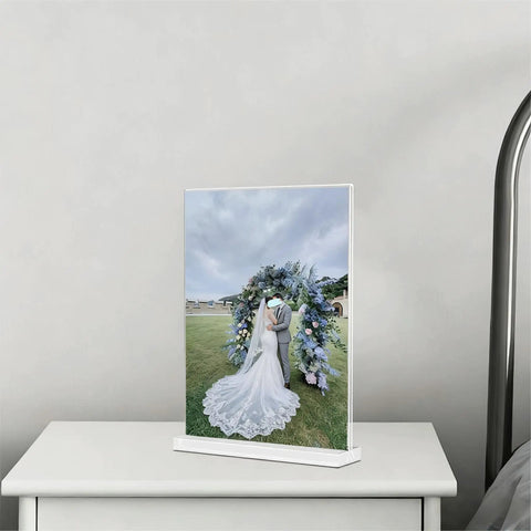 Clear Acrylic Sign Holder 4x6 Inches Three Pack T Shape Desktop Display Stand Double Sided Vertical Table Sign Holder For Restaurants Office Shop Wedding showcasing a wedding photo on a bedside table.