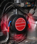 Top Shelf Automatic Car Fire Extinguisher Hardened Aluminum Body in engine bay among wiring harness.