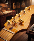 Top Tier Brass Guitar Roller String Retainers Fit Electric Guitars Perfectly on headstock showing smooth golden finish.