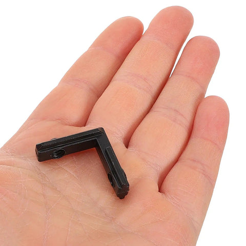 Level Up Your Build With These Sick L-Shape Interior Corner Connectors For 2020 T-Slot Aluminum Profiles in hand, showcasing size and material.