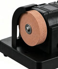 Close-up of the Badass Compact Table Grinder featuring a dual polish disc for quick blade sharpening and rust stripping.