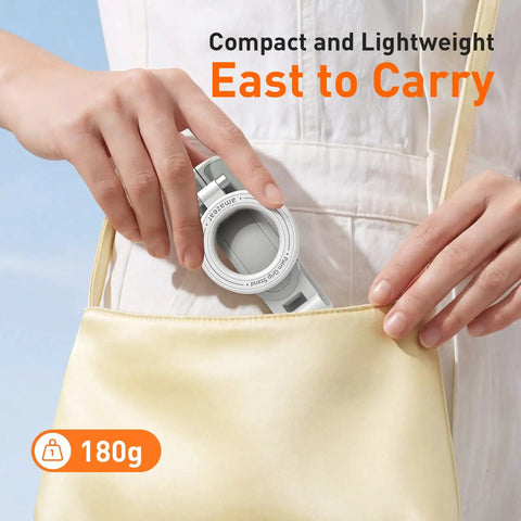 Person placing Phone Camera Grip With Selfie Stick Tripod Magnetic Mount And Detachable Wireless Shutter Button into a small handbag.