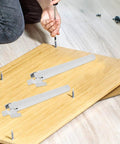 Installing Four Pack White Plastic Adjustable Furniture Legs With Built Tough Iron Frame on wood panel.