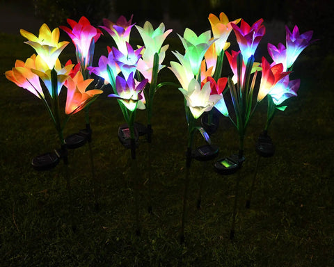 Solar Garden Stake Lights 8 Pack With 32 Lily Flowers Waterproof 7 Color Changing LED Landscape Lights glowing at night