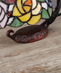 Close-up of Rose Tiffany Style Stained Glass Table Lamp With Six Inch Lampshade on sturdy cast iron base, colorful design