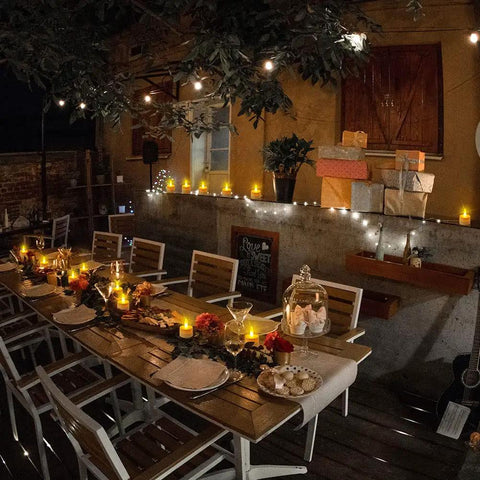Outdoor evening table setting with Rechargeable Tea Lights With Remote 100 Hour Flicker Waterproof LED Candles for decor