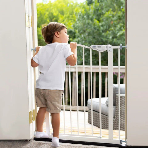 Child standing near Adjustable Baby Gate For Pets 29 To 39.6 Inches Wide, 30 Inch Tall, Auto Close On Both Sides, White.