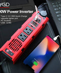Tailgate Tough 200W Car Power Inverter Converts 12V Dc To 110V Ac No Hassle With Dual Us Sockets Super Fast 2 4 Amp Usb Ports And Type C For Weekend Warriors, red inverter with dual AC sockets and USB ports charging a phone.