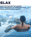Person relaxing in hot spring with snowy mountains, promoting Lithium Orotate 5mg Chelated Supplement For Mood Support.