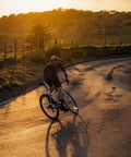 Cyclist on a road bike during sunset, highlighting Two Pack 700C Road Bike Inner Tubes 35 to 43 Millimeters With 48 Millimeter Schrader Valve