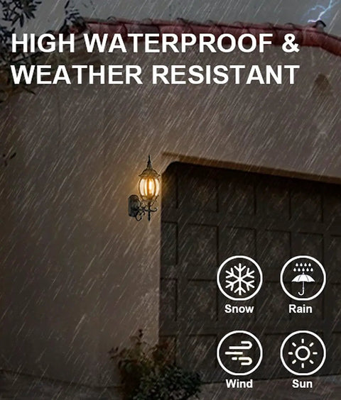 Two Pack Outdoor Wall Lanterns Waterproof Exterior Sconce Lights in matte black on garage wall during rain, showing weather resistance.