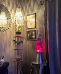 Room with cozy lighting including Plug In Rattan Pendant Light With Woven Bamboo Basket Shade, Dimmable Wicker Hanging Lamp, and a pink lava lamp.