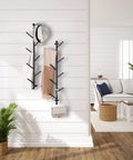 2 Pack Dope Wall Mounted Coat Rack With Rotating Hook Branches in a living room, holding hat, scarves, and bag
