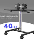 Mobile Laptop Standing Desk With Adjustable Height And Smooth Wheels supporting a 40 lbs weight on black surface.