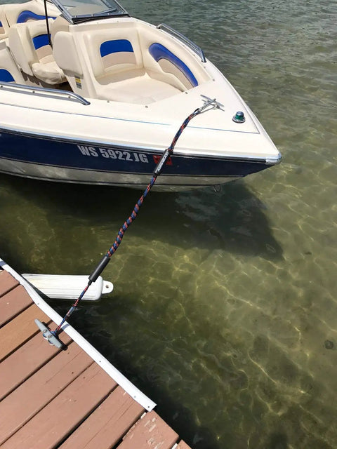 Badass Boat Bungee Dock Lines For Quick Mooring And Wave Blocking Must Have Watercraft Accessories For Pontoon And Bass Boats Plus Jet Skis Five Foot Elastic Mooring Ropes That Lock Solid Anytime A Sweet Gift For Fellas Out On The Water securing a boat to a dock with a bungee line.