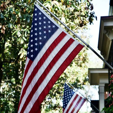 American Flag 3x5 Outdoor Heavy Duty Flag With Embroidered Stars And Sewn Stripes, Fade Resistant Exterior Grade, Brass Grommets displayed on porch