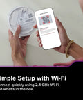 Person scanning QR code on App Enabled Hardwired Smart Smoke And Carbon Monoxide Detector With AA Battery Backup, Voice Alerts