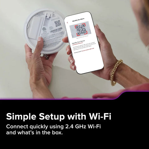 Person scanning QR code on App Enabled Hardwired Smart Smoke And Carbon Monoxide Detector With AA Battery Backup, Voice Alerts