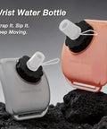 Handsfree Wrist Water Bottle For Outdoor Sports On The Go Hydration Gear, 200ml silicone bottle in gray and pink on rocky surface