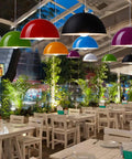 Colorful ceiling pendant light fixtures in a dining setting, featuring a glossy dome semicircle hanging lamp design.