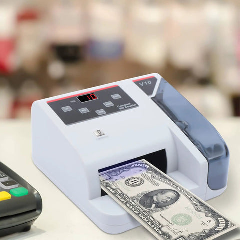 Money Counter Machine With UV MG WM Counterfeit Detection on table with bill being counted, compact design, LED display visible.