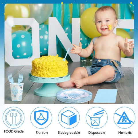 Smiling child with cake and Blue Hot Air Balloon Party Supplies Set For 24 Guests 120 Pcs Disposable Dinnerware.