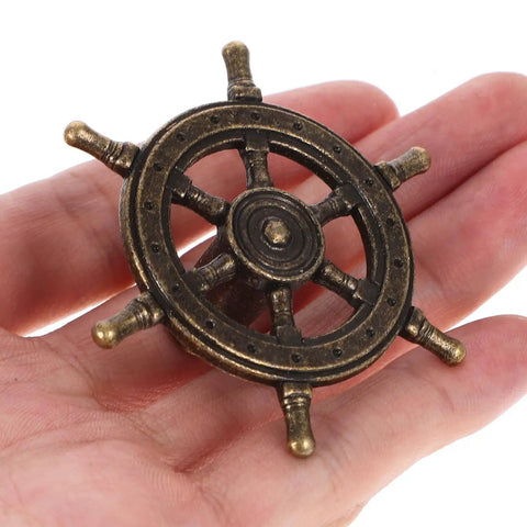 Close-up of antique bronze steering wheel door pull from 4 Piece Antique Cabinet Handles Set