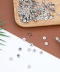 Hardcore Stainless Steel Chicago Screw Rivets Kit With Phillips Heads And 50 Pack of shiny reusable fasteners on a wooden tray.