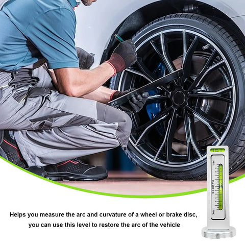 Mechanic using Dead Nuts Accurate Magnetic Wheel Alignment Gauge for fast camber adjustments on a car's wheel.
