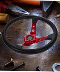 Universal 14 Inch PU Racing Steering Wheel for Cars Golf Carts and Trucks with Concave Red Grip on wooden table