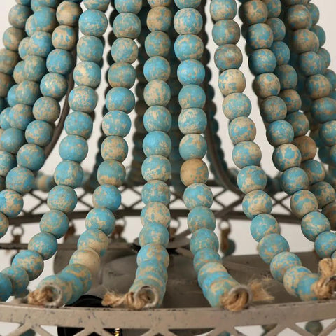 Close-up of blue wooden beads on the Three Light Wood Beaded Chandelier in Rustic Farmhouse Vibe fixture.