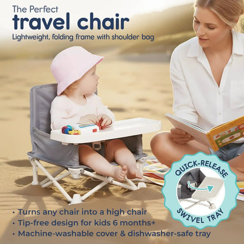 Baby using OmniBoost Travel Booster Seat With Tray on beach alongside adult reading book